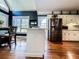 Bright kitchen featuring hardwood floors, a center island, stainless steel refrigerator and plenty of natural light at 2319 Lochinver Ln, Conyers, GA 30094