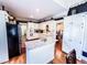 Spacious kitchen featuring an island, granite countertops, white cabinets, and stainless steel appliances at 2319 Lochinver Ln, Conyers, GA 30094