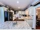 Bright kitchen with a granite island, stainless steel refrigerator, and lots of cabinets at 2319 Lochinver Ln, Conyers, GA 30094