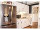 Kitchen features stainless steel refrigerator, microwave, and cooktop with granite countertops at 2319 Lochinver Ln, Conyers, GA 30094