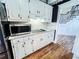 Updated kitchen featuring sleek countertops, stainless steel microwave and cooktop, and custom cabinetry at 2319 Lochinver Ln, Conyers, GA 30094