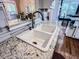 Close-up of a kitchen sink with granite countertops, white cabinets, and tile backsplash at 2319 Lochinver Ln, Conyers, GA 30094