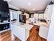 Bright kitchen with hardwood floors, a center island with granite countertop, and stainless steel appliances at 2319 Lochinver Ln, Conyers, GA 30094