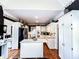 Bright kitchen with granite island, white cabinets, stainless steel fridge, with access to the stairwell at 2319 Lochinver Ln, Conyers, GA 30094