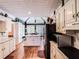 Modern kitchen with white cabinets, an island, stainless steel appliances, and ample natural light at 2319 Lochinver Ln, Conyers, GA 30094
