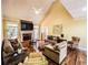 Spacious living room with a fireplace, vaulted ceilings, and hardwood floors at 2319 Lochinver Ln, Conyers, GA 30094