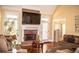 Living room features brick fireplace, vaulted ceilings, hardwood floors, and natural light at 2319 Lochinver Ln, Conyers, GA 30094