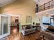 Inviting living room with a balcony, hardwood floors, and an open doorway at 2319 Lochinver Ln, Conyers, GA 30094