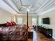 Comfortable main bedroom with trey ceilings, hardwood floors, and a cozy seating area at 2319 Lochinver Ln, Conyers, GA 30094