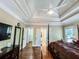 Spacious main bedroom featuring a tray ceiling with ceiling fan and well-maintained hardwood flooring at 2319 Lochinver Ln, Conyers, GA 30094
