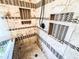 Detail of a glass enclosed shower with built-in shelves and decorative tile at 2319 Lochinver Ln, Conyers, GA 30094