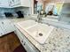 A close up of the granite countertop with double sink and stainless faucet, with a coffee maker at 2319 Lochinver Ln, Conyers, GA 30094