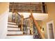 Elegant staircase featuring decorative iron railings and hardwood steps, leading to the upper level of the home at 2319 Lochinver Ln, Conyers, GA 30094