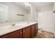 Well-lit bathroom features a double sink vanity with cherry wood cabinets and a shower-tub combination at 859 Walking Stick Trl, Auburn, GA 30011