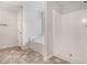 Bathroom featuring a soaking tub with tile backsplash, separate shower, and neutral tile floors at 859 Walking Stick Trl, Auburn, GA 30011