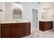 Bright bathroom featuring double vanities with dark wood cabinets and neutral countertops plus modern lighting fixtures at 859 Walking Stick Trl, Auburn, GA 30011