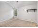 Bedroom featuring neutral carpet, a single window with blinds, and a minimalist shelf at 859 Walking Stick Trl, Auburn, GA 30011