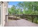 Relax on the outdoor wooden deck overlooking the lush green backyard at 859 Walking Stick Trl, Auburn, GA 30011