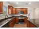 Modern kitchen featuring granite countertops, stainless steel appliances, and dark wood cabinetry at 859 Walking Stick Trl, Auburn, GA 30011
