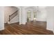 Bright living area with hardwood floors, arched entryways, and staircase with wrought iron railing at 859 Walking Stick Trl, Auburn, GA 30011
