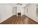 Bright living room with hardwood floors, fireplace, ceiling fan, and natural light at 859 Walking Stick Trl, Auburn, GA 30011