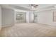 Spacious main bedroom with tray ceiling, ceiling fan, neutral carpet, and natural light at 859 Walking Stick Trl, Auburn, GA 30011
