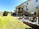 Backyard with a covered patio, stone fire pit, Adirondack chairs and a grassy lawn at 2671 Moon Chase Ln, Buford, GA 30519