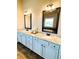 Bathroom featuring dual sinks and elegant vanity with granite countertops, providing a luxurious and functional space at 2671 Moon Chase Ln, Buford, GA 30519