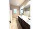 Well-lit bathroom featuring a double vanity, large mirror, tile flooring, and ample counter space at 2671 Moon Chase Ln, Buford, GA 30519