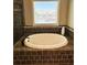 Bathroom featuring a soaking tub with modern fixtures, and providing a relaxing spa-like experience at 2671 Moon Chase Ln, Buford, GA 30519