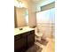 Bathroom featuring a dark vanity with white countertop, tile flooring and a bathtub with shower at 2671 Moon Chase Ln, Buford, GA 30519
