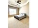 Comfortable bedroom featuring a ceiling fan, and natural light from a window to create a relaxing atmosphere at 2671 Moon Chase Ln, Buford, GA 30519