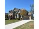 Beautiful two-story home featuring a three-car garage and a well-maintained lawn in a suburban neighborhood at 2671 Moon Chase Ln, Buford, GA 30519