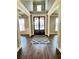 Grand foyer featuring hardwood floors, ornate columns, a decorative rug, and a double-door entry at 2671 Moon Chase Ln, Buford, GA 30519