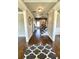 Welcoming entryway with hardwood floors, staircase with dark wood railing, and neutral wall paint at 2671 Moon Chase Ln, Buford, GA 30519