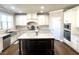 Bright kitchen showcases granite counters, stainless appliances, and dark island with breakfast bar at 2671 Moon Chase Ln, Buford, GA 30519