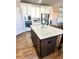 Kitchen features white cabinets with granite countertops, a dark island, and stainless steel appliances at 2671 Moon Chase Ln, Buford, GA 30519