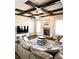 Comfortable living room with hardwood floors, coffered ceilings, stone fireplace, and a large sectional sofa at 2671 Moon Chase Ln, Buford, GA 30519