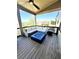 Covered patio with an outdoor sectional sofa, coffee table with fire pit and ceiling fan at 2671 Moon Chase Ln, Buford, GA 30519