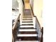 Wooden staircase showcases a metal railing and leads to upper level at 2671 Moon Chase Ln, Buford, GA 30519
