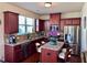 Modern kitchen with stainless steel appliances, granite countertops, and cherry cabinets at 3315 Sardis Bend Dr, Buford, GA 30519