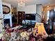 Cozy living room featuring a fireplace, elegant chandelier, and hardwood floors, creating a warm and inviting atmosphere at 3315 Sardis Bend Dr, Buford, GA 30519