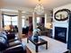 Open-concept living room with hardwood floors, fireplace, and decorative chandelier at 3315 Sardis Bend Dr, Buford, GA 30519
