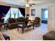 Carpeted living room with comfortable seating, ceiling fan, and view to bedroom at 3315 Sardis Bend Dr, Buford, GA 30519
