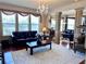 Bright living room featuring hardwood floors, a chandelier, and comfortable seating at 3315 Sardis Bend Dr, Buford, GA 30519
