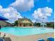 Community pool with inviting blue water, lounge chairs, and a mushroom fountain, perfect for summertime fun and relaxation at 3315 Sardis Bend Dr, Buford, GA 30519