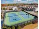 Aerial view of well-maintained tennis courts surrounded by lush landscaping, offering residents an active and recreational lifestyle at 3315 Sardis Bend Dr, Buford, GA 30519