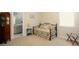 Comfortable carpeted bedroom with stylish iron daybed and ensuite bathroom at 351 Senna St, Marietta, GA 30064