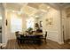 Elegant dining room with a modern chandelier, coffered ceiling, hardwood floors, and a wooden dining set at 351 Senna St, Marietta, GA 30064