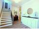 Bright entryway with hardwood floors, a staircase, and decorative white cabinet at 351 Senna St, Marietta, GA 30064